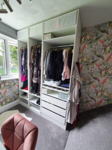 A creative use of a small box room which has been transformed in to a walk in wardrobe and vanity area. It has bold wallpaper and lots of clever storage
